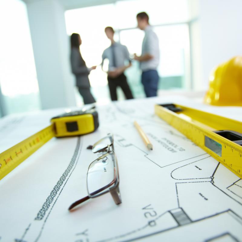 Engineering,objects,on,background,of,group,of,colleagues